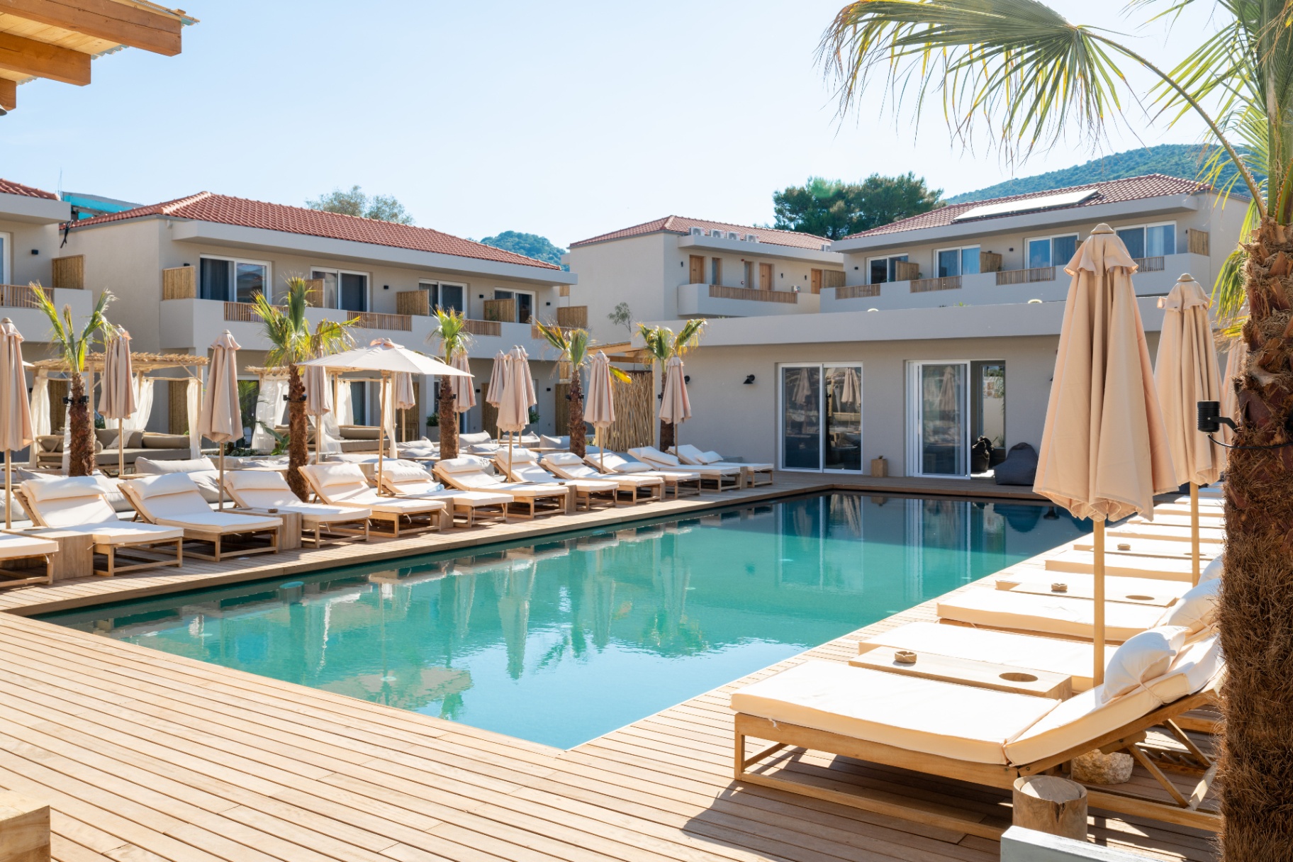 Outdoor pool with sun loungers and cabanas
